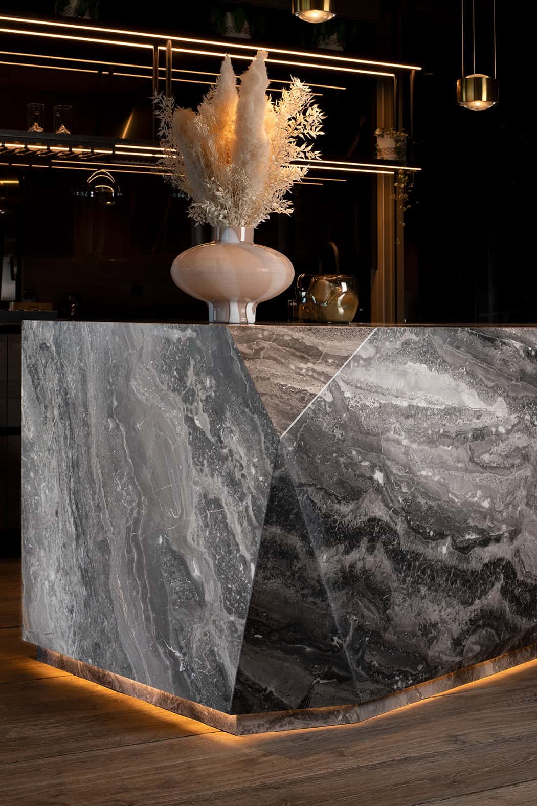 Îlot de cuisine en pierre naturelle réalisé sur mesure avec assemblage bookmatch et coupe d'onglet par Unique Onyx en Suisse.